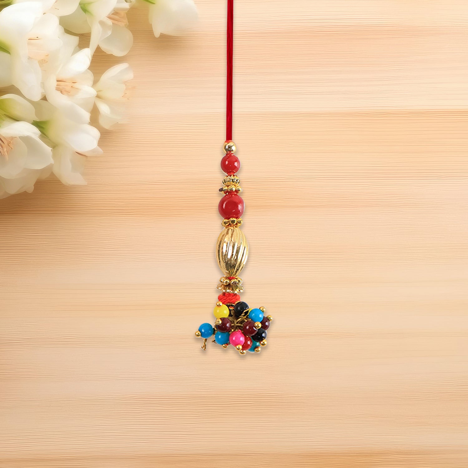 Bhabhi Lumba Rakhi With Multicolor Beads And Golden Floral Charm On Red Thread Bhabhi Lumba Rakhi With Multicolor Beads And Golden Floral Charm On Red Thread